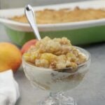 A serving of peach cobbler with ice cream.