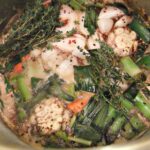 Photo of herbs and vegetables in a pot to make turkey brine.