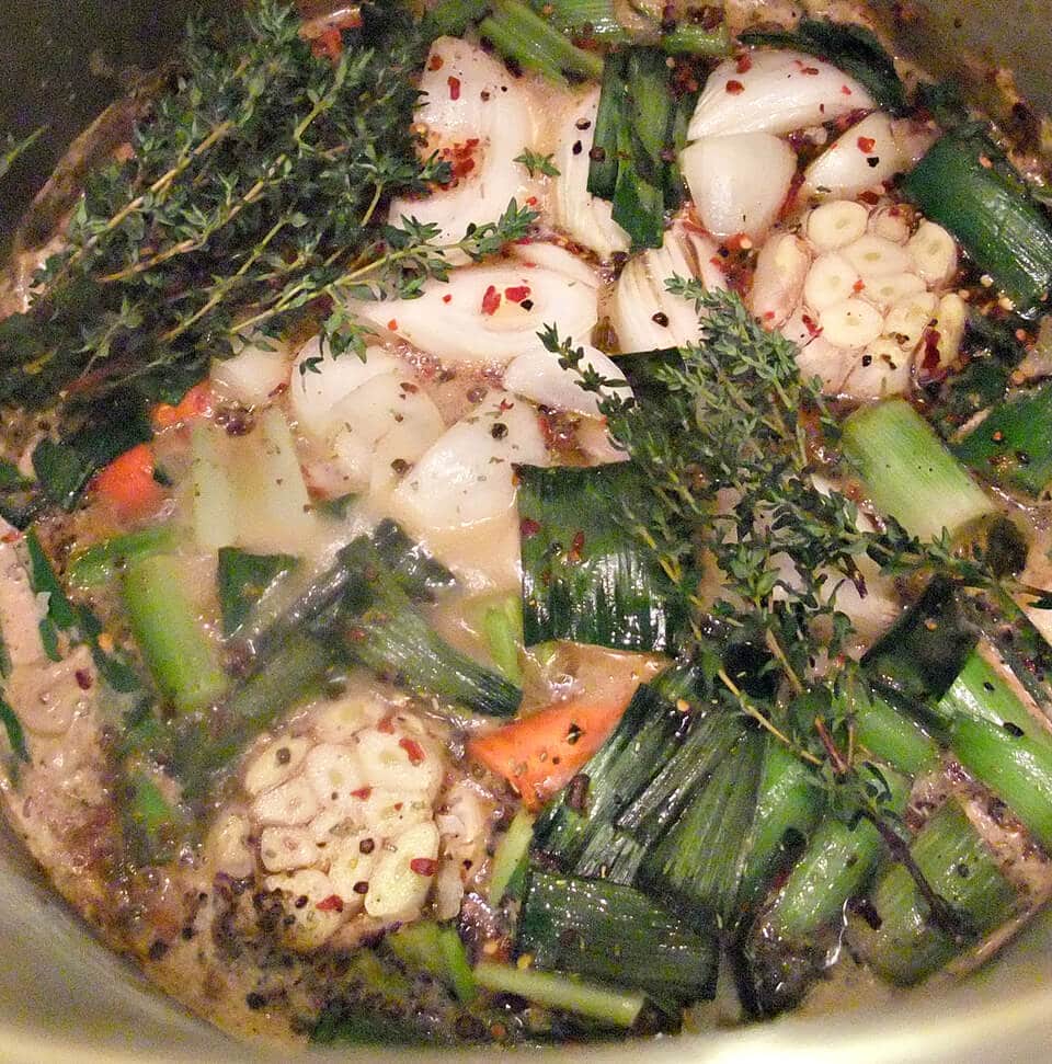 Photo of herbs and vegetables in a pot to make turkey brine.