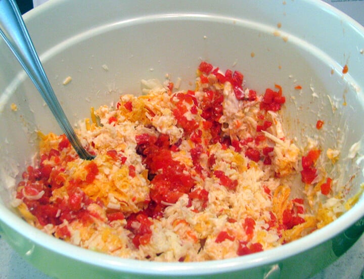 Bowl of cheese, pimentos, and mayonnaise to make homemade pimento cheese.