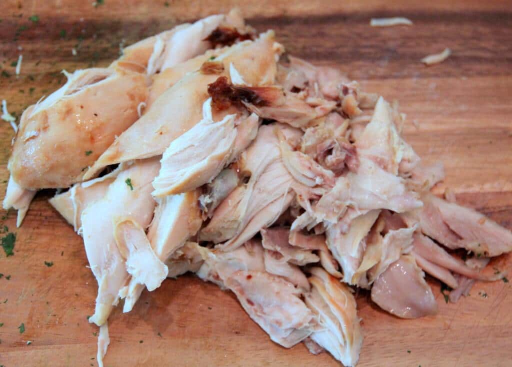 Chopped chicken on a cutting board to make chicken salad.