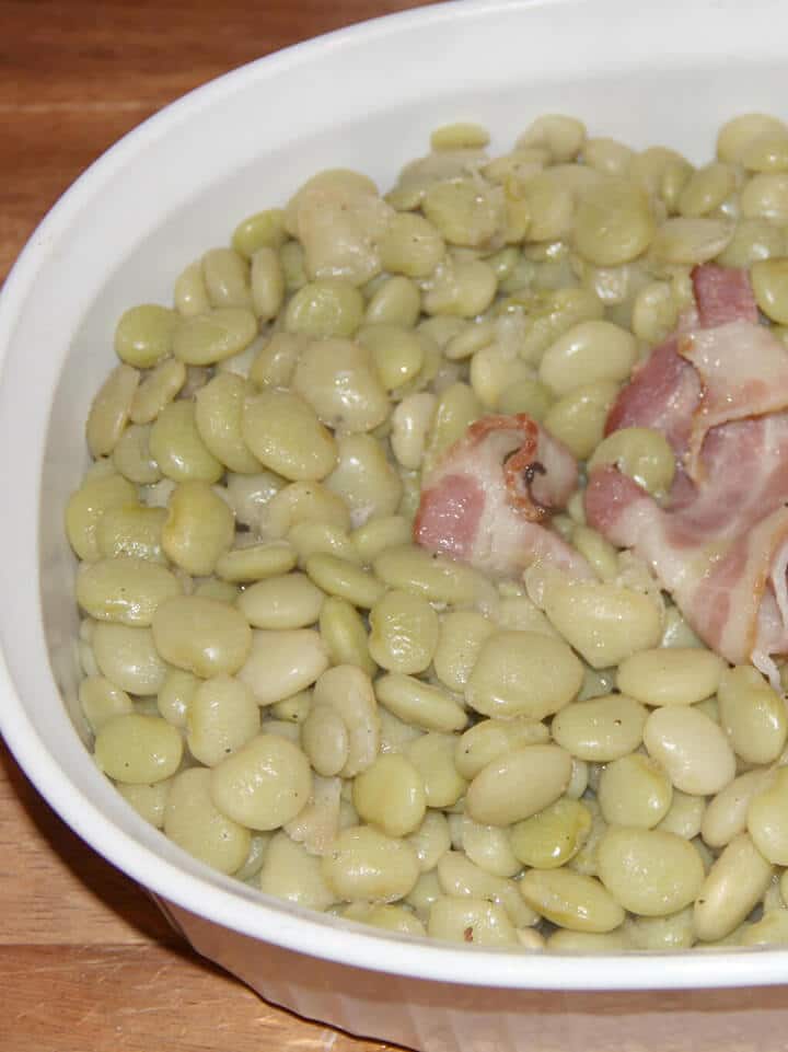 Cooked butter beans recipe in a dish with bacon. 