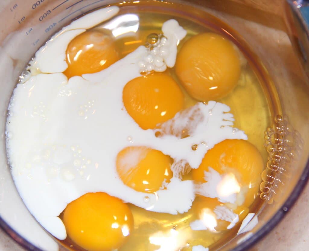Eggs and milk in a bowl.