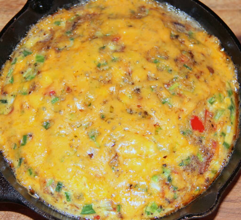 Oven baked omelet in a cast iron skillet.