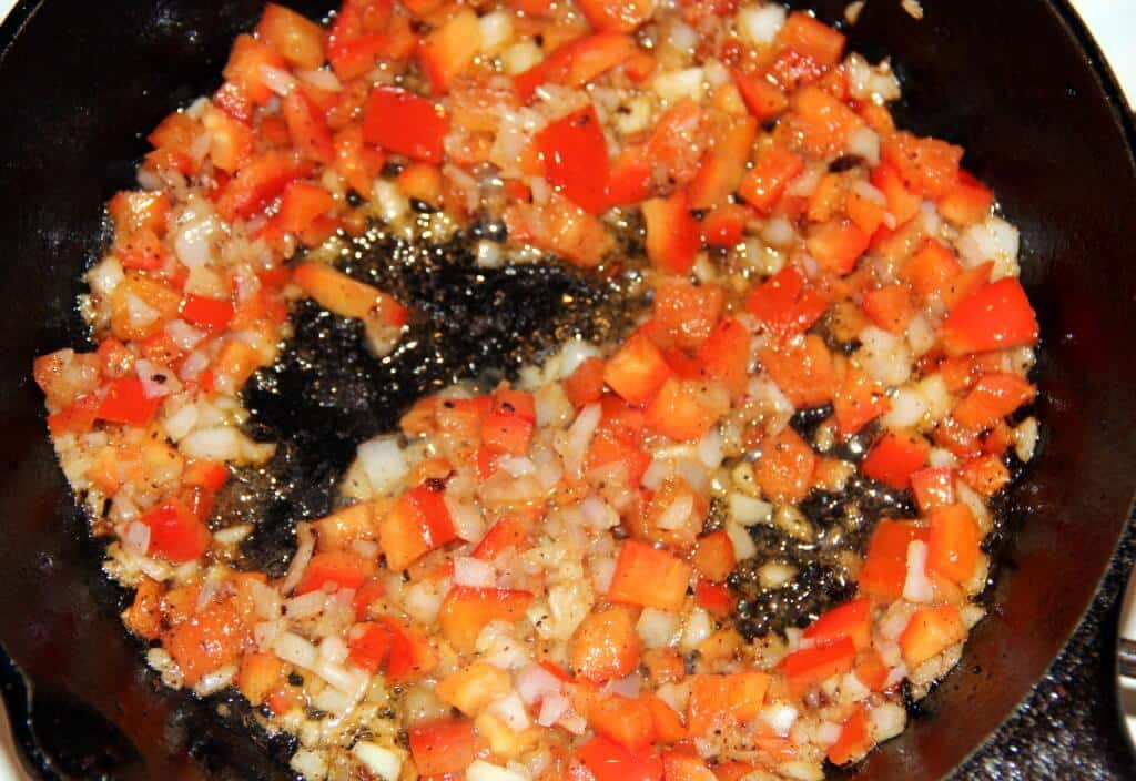 Peppers and onions sauteed in a skillet.