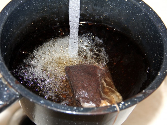 pouring water into a pot to make tea.