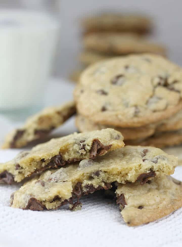 A stack of chocolate chip cookies on a white towel.
