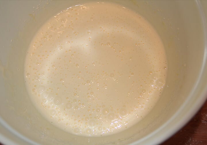 A bowl of milk and eggs mixed.