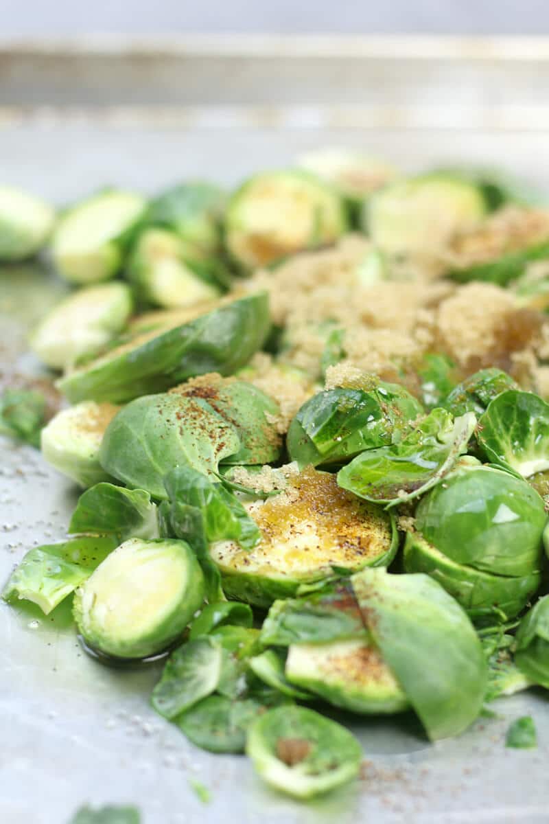 Closeup of Brussels Sprouts on the baking sheet with brown sugar and spices. 