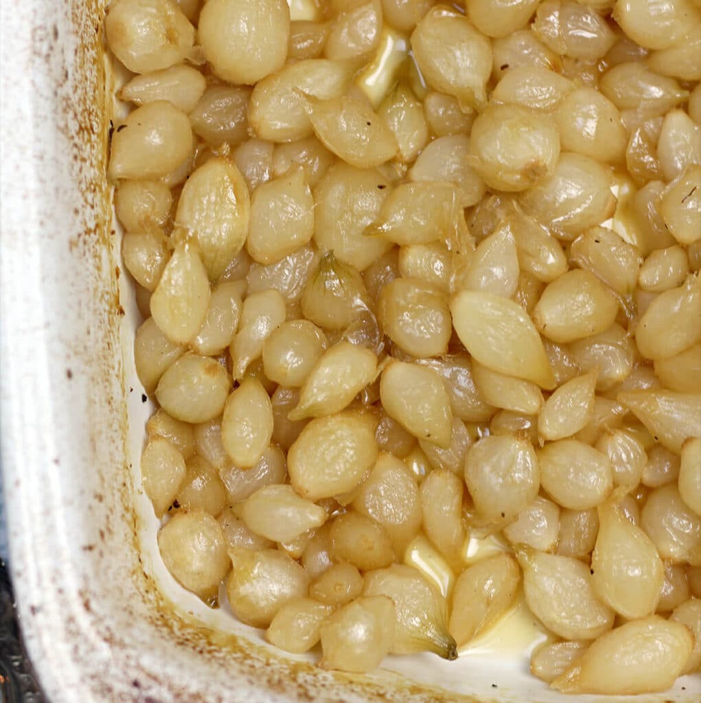 A dish of roasted pearl onions.