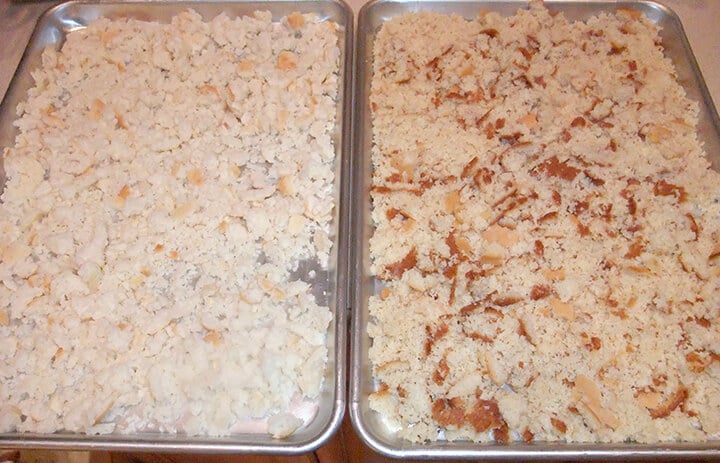 Cornbread and biscuits drying on baking sheets for cornbread dressing.