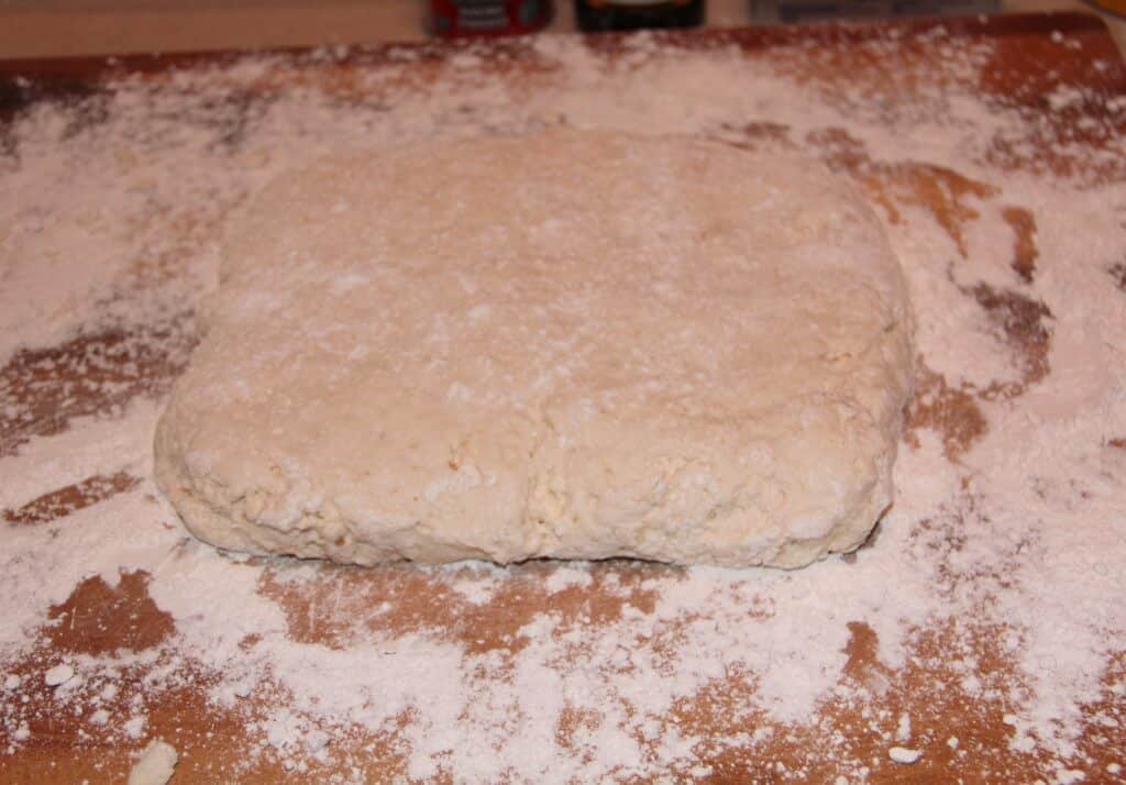 cinnamon roll dough on a floured surface