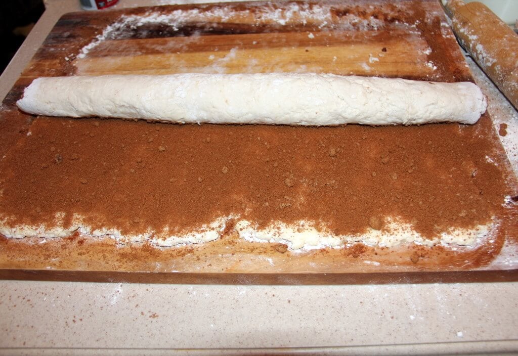 cinnamon roll dough sprinkled with cinnamon sugar mixture