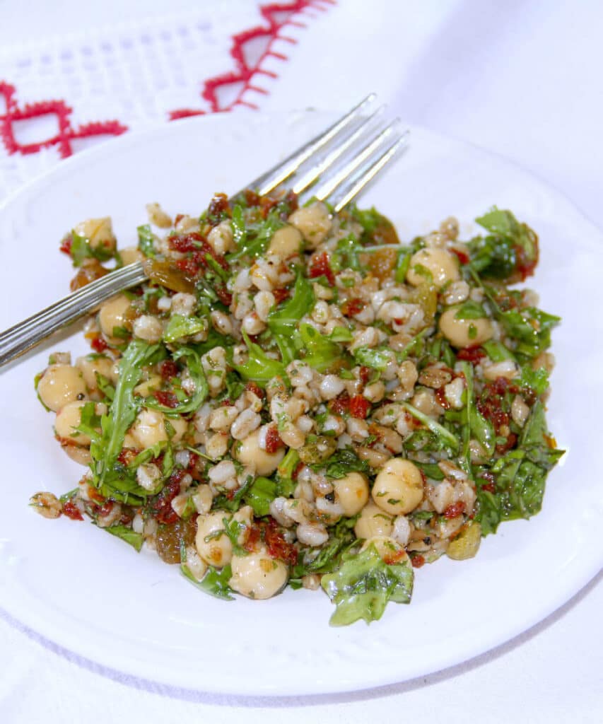 Farro Salad—a mix of farro, chickpeas, sun-dried tomatoes, arugula, and golden raisins, it hits all the right notes. Savory with just a touch of sweetness.