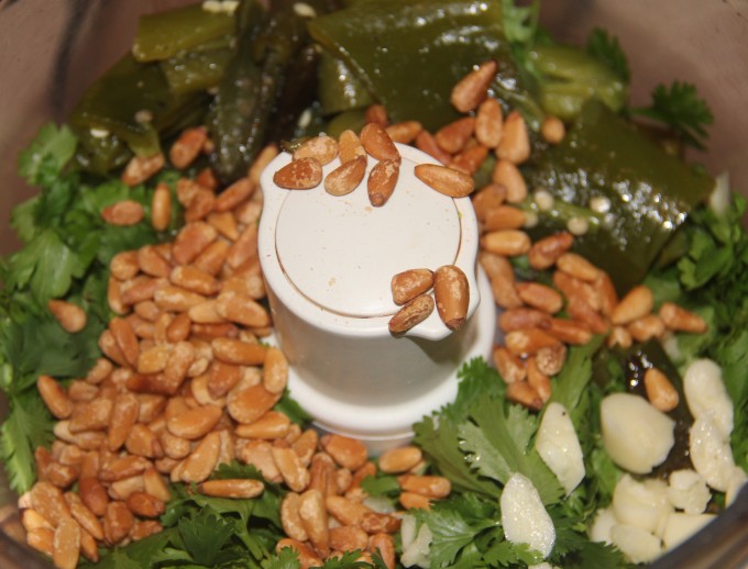 Pine nuts, jalapenos and cilantro in food processor.