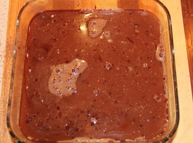 Gently and slowly pouring water over chocolate cobbler batter.