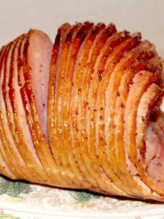 Baked ham with glaze on a platter.