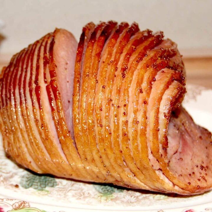 Baked ham with glaze on a platter.