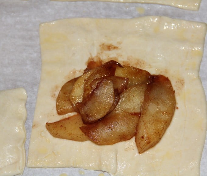 placing apples on puff pastry