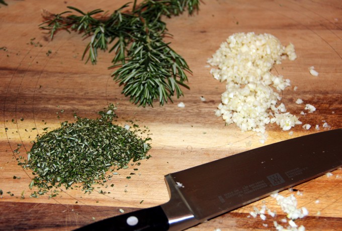 chopping rosemary and garlic