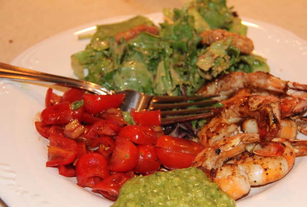 tomato salad on a plate with shrimp and salad