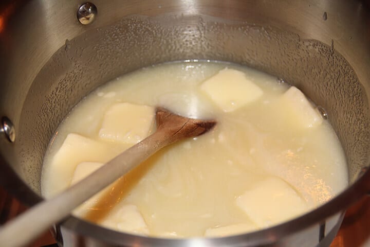 Butter and sugar melting in pot for caramel icing. 