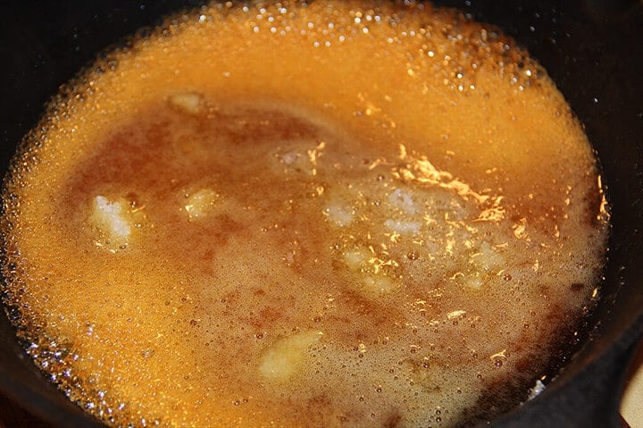 Caramel sugar starting to caramelize in skillet.