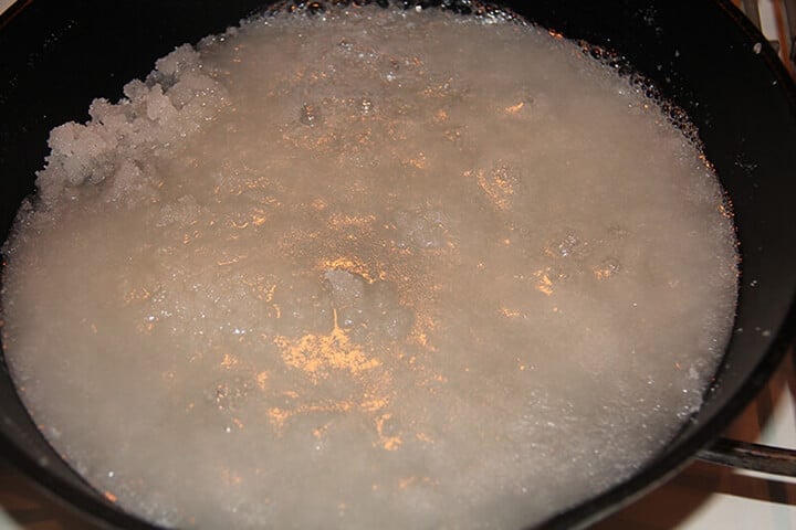 Melted sugar in skillet for caramel cake icing.