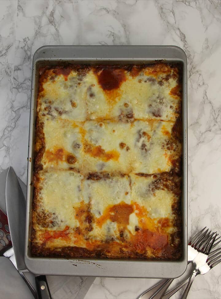 Fully baked pan of lasagna without ricotta ready to serve.