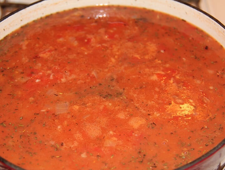 Pot of tomato soup simmering on the stove.