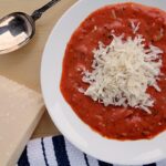 This Easy Tomato Soup Recipe is ready in under an hour! It's made with canned tomatoes, dried herbs, fresh onion, and cream—just add a grilled cheese!