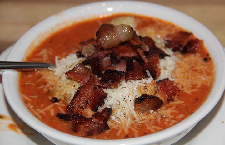 Easy Tomato Soup recipe topped with bacon and parmesan cheese.