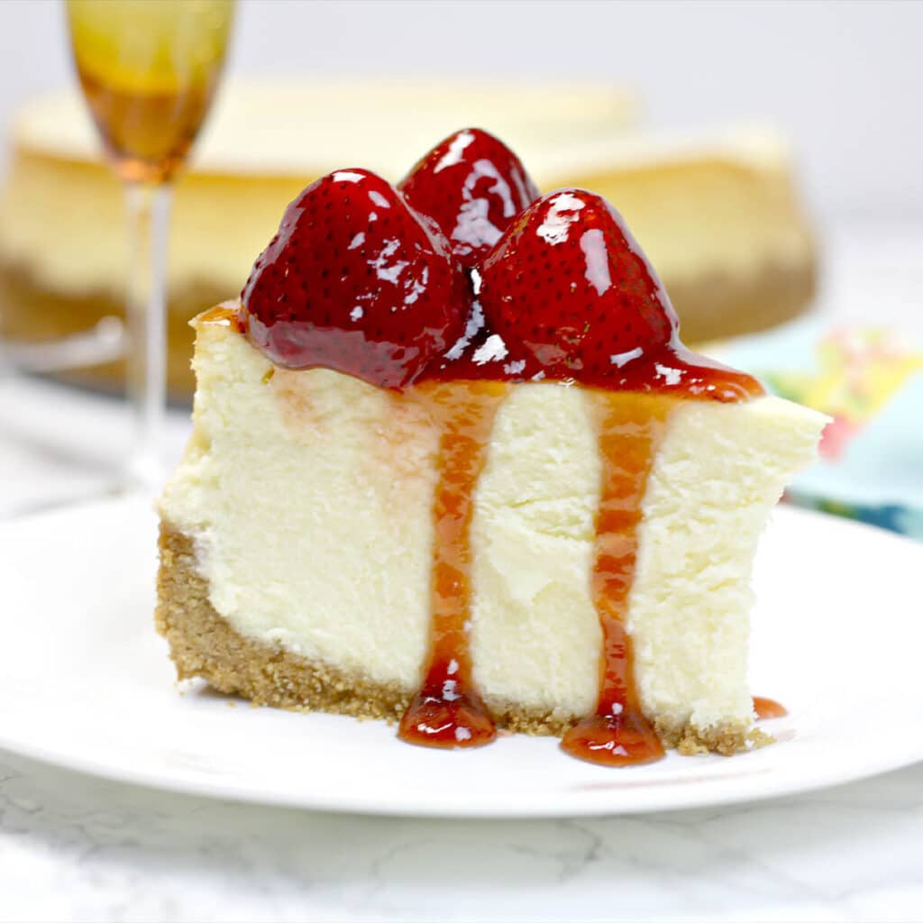 A close up of a slice of cheesecake on a plate.