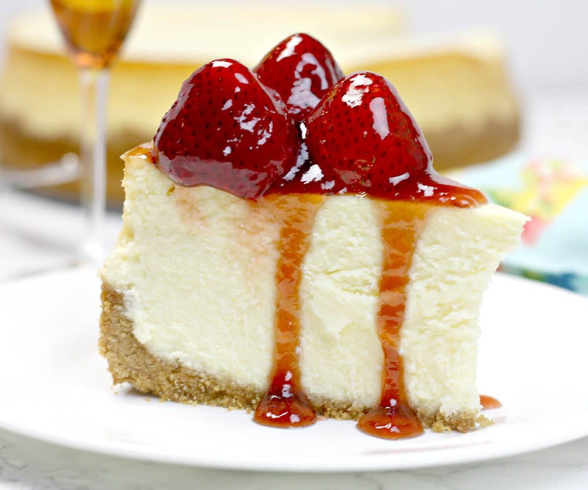 A close up of a slice of cheesecake on a plate.