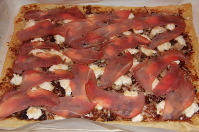 proscuttio slices on hot pizza
