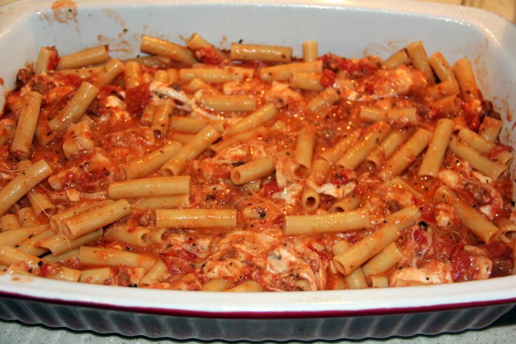 noodles and sauce in a baking dish for baked ziti