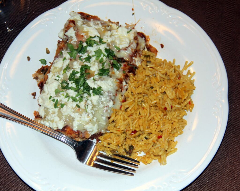 Beef Enchiladas on a plate with rice. 