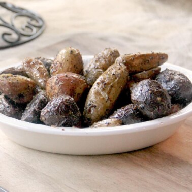Roasted fingerling potatoes with garlic and Italian herbs are slightly crispy on the outside and soft on the inside and a choice accompaniment to almost any meal.