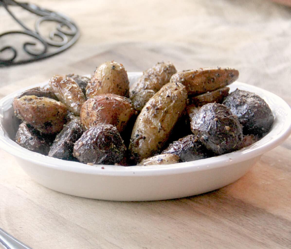 Roasted fingerling potatoes with garlic and Italian herbs are slightly crispy on the outside and soft on the inside and a choice accompaniment to almost any meal.