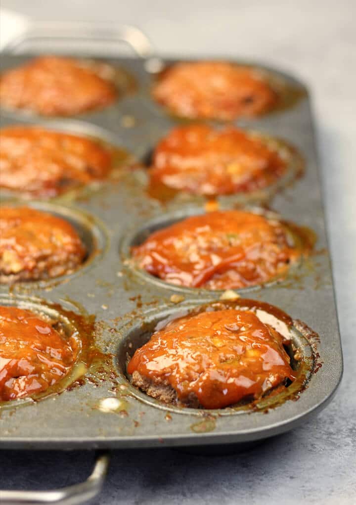 A muffin pan full of easy meatloaf muffins after they have baked.