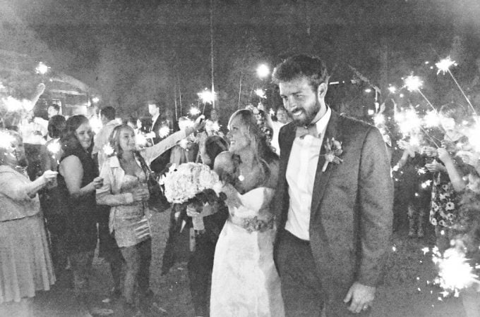 newlyweds leaving the reception through a trail of sparklers