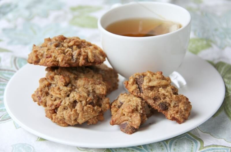 A plate of breakfast cookies and a cup of hot tea.