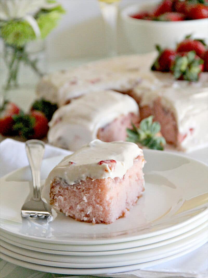 A luscious strawberry sheet cake with fresh strawberries and cream cheese frosting.