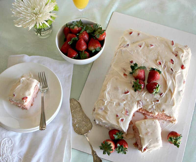 A luscious strawberry sheet cake with fresh strawberries and cream cheese frosting.