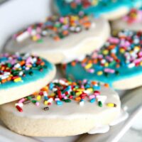 A delicious and easy sugar cookie recipe with simple icing that's quick and easy to apply. And sprinkles, of course! Kids love these cookies.