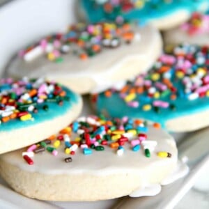 A delicious and easy sugar cookie recipe with simple icing that's quick and easy to apply. And sprinkles, of course! Kids love these cookies.