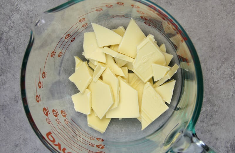 A bowl of chopped white chocolate ready to melt for frosting.