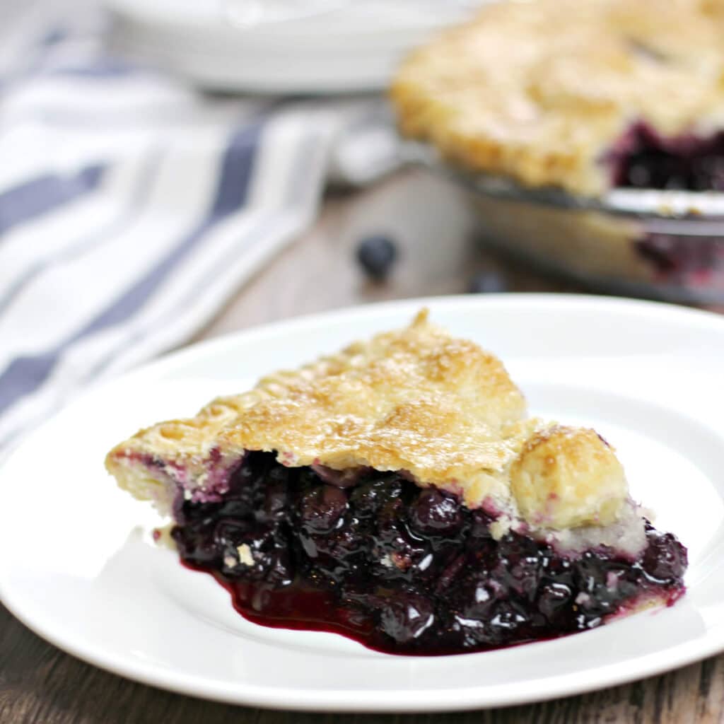 Homemade blueberry pie made with fresh blueberries is the perfect dessert—add a little whipped cream or vanilla ice cream on the side for a sweet summer treat!