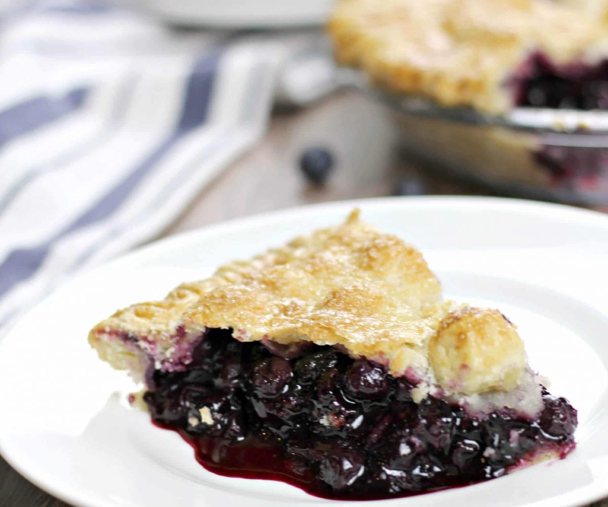Homemade blueberry pie made with fresh blueberries is the perfect dessert—add a little whipped cream or vanilla ice cream on the side for a sweet summer treat!