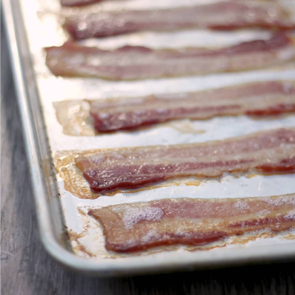Oven cooked bacon is crisp and perfectly browned if done correctly! Forget the mess and standing over the skillet--oven cooking is the way to go!